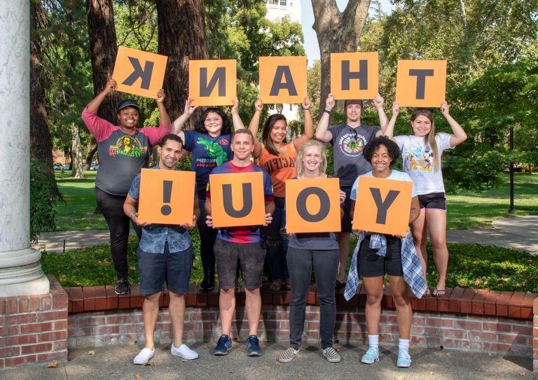 students holding thank you signs