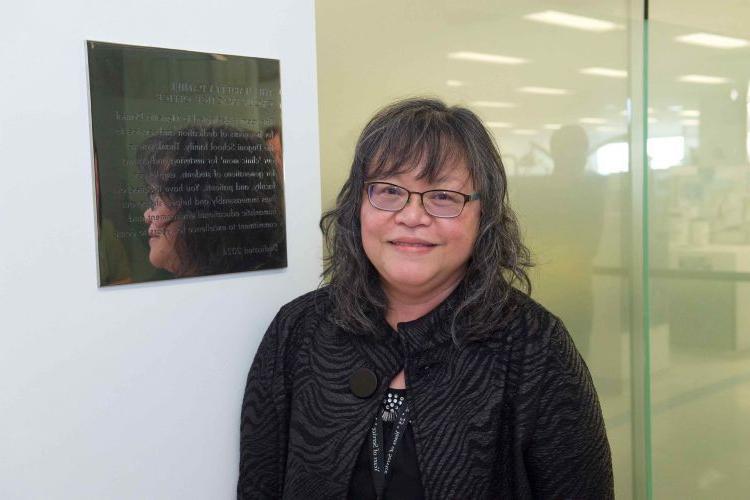 Marietta in front of her plaque